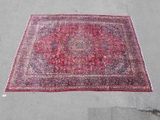 A large wool rug on red ground (383 x 295cm)