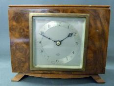 A c1930 Elliot clock in walnut case of rectangular design the Arabic dial with blued steel hands,