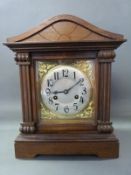 A c1900 architectural style mantel clock with silvered Arabic dial,