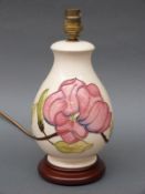 A Moorcroft table lamp in the Hibiscus pattern on cream ground,
