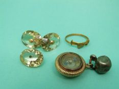 A yellow metal fob set with a compass and a citrine cufflink