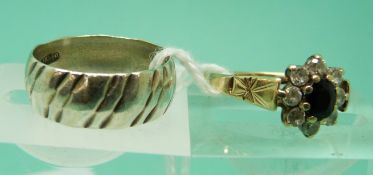 A 9ct gold ring set with a sapphire surrounded by cubic zirconia and a silver ring