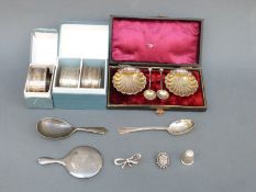Three boxed hallmarked silver napkin rings, a silver caddy spoon,