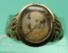 A Victorian mourning ring set with a photograph and engraved June 1868