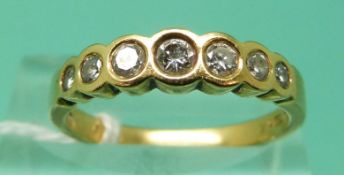 An 18ct gold ring set with seven graduated diamonds (Size O), weight 3.