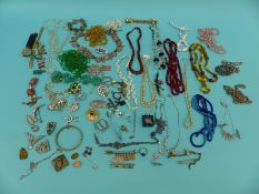 A collection of costume jewellery to include glass beads, silver brooch, beaded necklaces, paste,