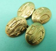 A pair of gold cufflinks,
