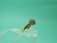 An 18ct gold ring set with diamonds in a cluster (Size K), weight 3.