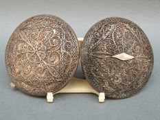 A white metal filigree compact with scrolling floral design, diameter 7cm,