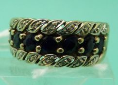 A 9ct gold ring set with a row of sapphires and two rows of diamonds (size M)