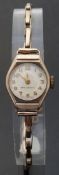 9ct gold ladies wristwatch with gold hands, Arabic numerals and engine turned face,