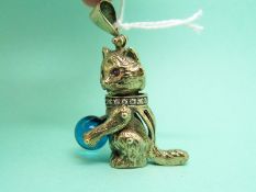 A 9ct gold pendant in the form of a cat with ruby eyes,