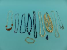 A collection of necklaces including two lapis lazuli, two ivory, garnet necklace,