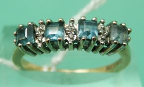 A 9ct gold ring set with square topaz and diamonds (size N)