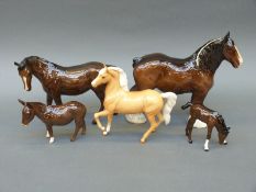 A collection of Beswick and Royal Doulton figures including palomino prancing Arab with box,