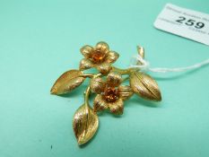 A 9ct gold brooch in the form of two flowers set with citrines, 9.
