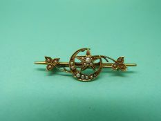A 15ct gold brooch set with seed pearls in the form of a crescent and star
