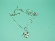 A 9ct white gold necklace set with diamonds in the form of a heart,