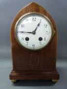 An Edwardian inlaid mahogany mitre shaped mantel clock with laurel leaf inlaid decoration,