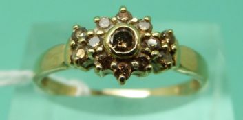 A 9ct gold ring set with brown diamonds in a cluster (size P)