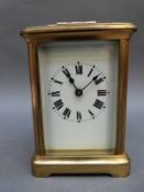 Brass corniche style French carriage clock with enamelled dial with bold Roman numerals with
