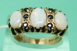 A 9ct gold ring set with three opals and sapphires (size N)