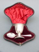 A cased Edward VII hallmarked silver egg cup and spoon, B'ham 1902.