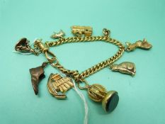 An 18ct gold bracelet with charms including 9ct gold cat and pig and two yellow metal seals