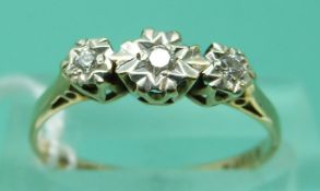 A 9ct gold ring set with three diamonds in an illusion setting (size O)