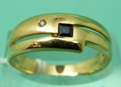 An 18ct gold ring set with a square sapphire, weight 4.