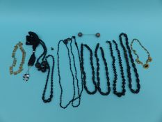 A collection of jet jewellery including carved necklaces, French jet,