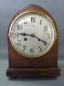 An oak mitre cased c1930 two train mantel clock with Arabic dial raised on bun feet,