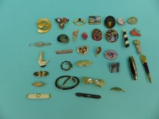 A collection of brooches including enamel, one in the form of a geisha girl, a Stratton tie clip,