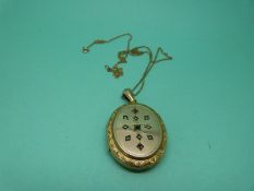 A Victorian yellow metal locket set with seed pearls on a 9ct gold chain
