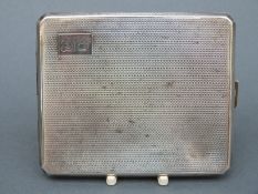 A hallmarked silver engine turned cigarette case, Birmingham 1942,