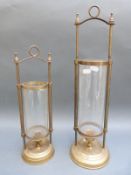 Two hanging brass and glass shaded candlesticks,