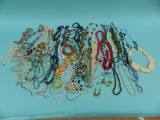 A collection of beads to include glass, faux pearls,