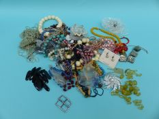 A collection of costume jewellery including beads, shell necklace,