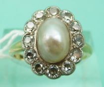 An 18ct gold Victorian ring set with a large natural saltwater pearl surrounded by old cut diamonds