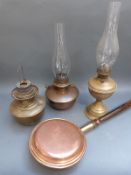Three vintage brass and copper oil lamps together with a copper bed pan