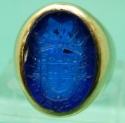 A yellow metal ring marked 14k set with a blue glass intaglio, 12.