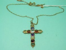 A yellow metal cross pendant set with amethysts, aquamarine,