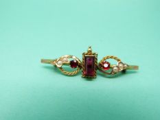 A 15ct gold brooch set with garnets and seed pearls (Chester 1906)