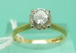 An 18ct gold ring set with a round brilliant cut diamond of approximately 1.