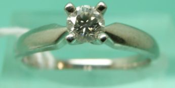 A platinum ring set with a round brilliant cut diamond (size M)