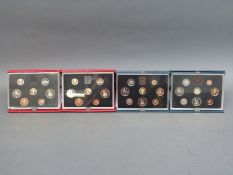 Four Royal Mint deluxe cased coin collections comprising 1983, 1984,