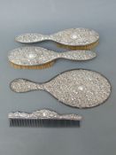 A Victorian hallmarked silver-mounted dressing table set comprising mirror and two brushes,