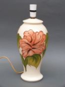 A Moorcroft lamp in the Hibiscus pattern on cream ground,