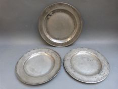 Three 18thC pewter plates, two having touch marks,