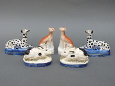 A pair of Staffordshire rabbits, a pair of Staffordshire dogs and another pair of similar dogs,